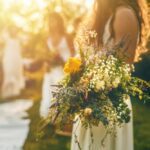 bouquets in hand at sunset