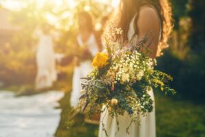 bouquets in hand at sunset